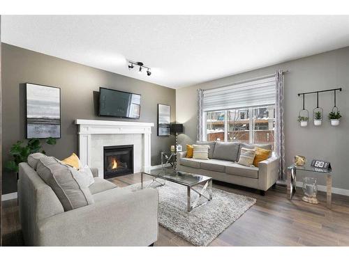 17 Riviera Bay, Cochrane, AB - Indoor Photo Showing Living Room With Fireplace