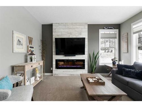 17 Riviera Bay, Cochrane, AB - Indoor Photo Showing Living Room With Fireplace