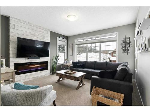 17 Riviera Bay, Cochrane, AB - Indoor Photo Showing Living Room With Fireplace