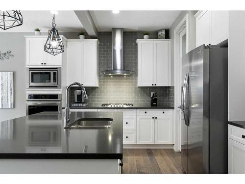 17 Riviera Bay, Cochrane, AB - Indoor Photo Showing Kitchen With Stainless Steel Kitchen With Double Sink With Upgraded Kitchen