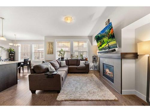 402-110 Coopers Common Sw, Airdrie, AB - Indoor Photo Showing Living Room With Fireplace