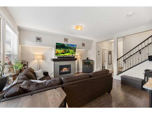 402-110 Coopers Common Sw, Airdrie, AB - Indoor Photo Showing Living Room With Fireplace