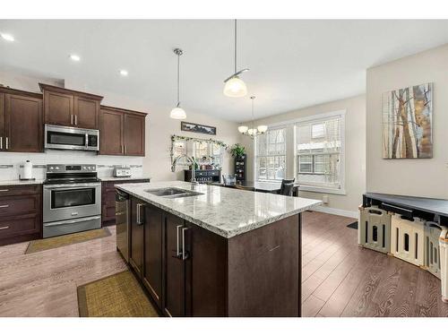 402-110 Coopers Common Sw, Airdrie, AB - Indoor Photo Showing Kitchen With Double Sink With Upgraded Kitchen