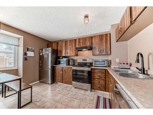 701-700 Allen Street Se, Airdrie, AB - Indoor Photo Showing Kitchen With Double Sink