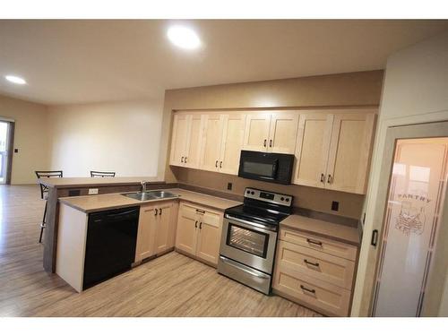 1322 B 20 Street, Didsbury, AB - Indoor Photo Showing Kitchen With Double Sink