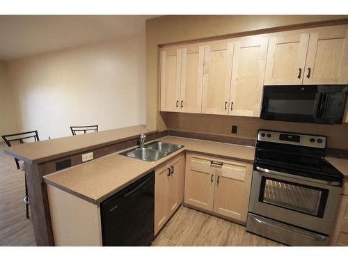 1322 B 20 Street, Didsbury, AB - Indoor Photo Showing Kitchen With Double Sink