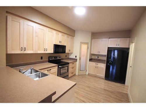 1322 B 20 Street, Didsbury, AB - Indoor Photo Showing Kitchen With Double Sink