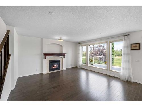 128 Tuscany Ravine Terrace Nw, Calgary, AB - Indoor Photo Showing Living Room With Fireplace