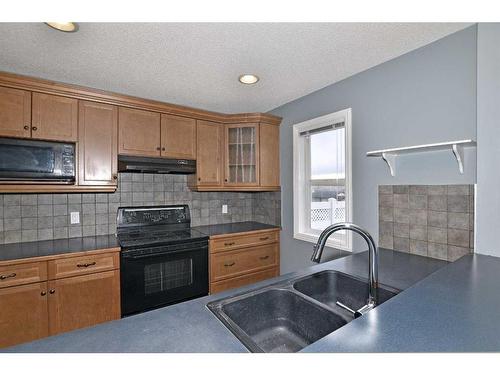 226 Evansmeade Close Nw, Calgary, AB - Indoor Photo Showing Kitchen With Double Sink