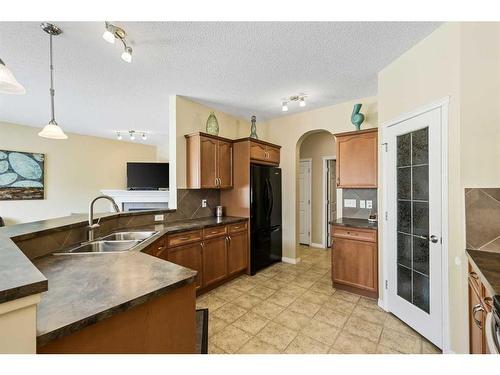 224 Silverado Range Heights Sw, Calgary, AB - Indoor Photo Showing Kitchen With Double Sink