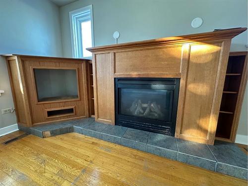 4618 48 Street, Olds, AB - Indoor Photo Showing Living Room With Fireplace