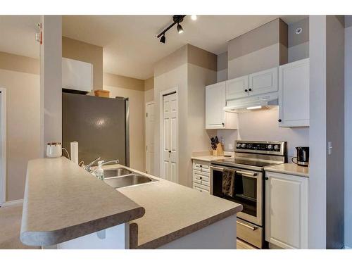 403-16 Poplar Avenue, Okotoks, AB - Indoor Photo Showing Kitchen With Double Sink