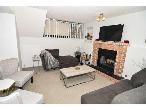 227 Costa Mesa Close Ne, Calgary, AB - Indoor Photo Showing Living Room With Fireplace