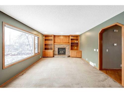 121 Mt Assiniboine Place Se, Calgary, AB - Indoor Photo Showing Living Room With Fireplace