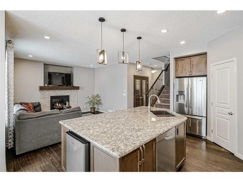 116 Auburn Glen Heights Se, Calgary, AB - Indoor Photo Showing Kitchen With Fireplace With Double Sink With Upgraded Kitchen