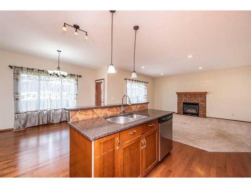 126 Panamount Street Nw, Calgary, AB - Indoor Photo Showing Kitchen With Fireplace With Double Sink