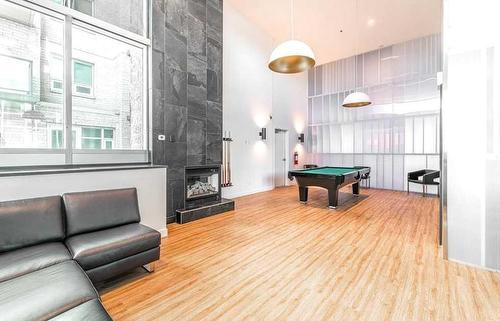 1303-210 15 Avenue Se, Calgary, AB - Indoor Photo Showing Living Room With Fireplace