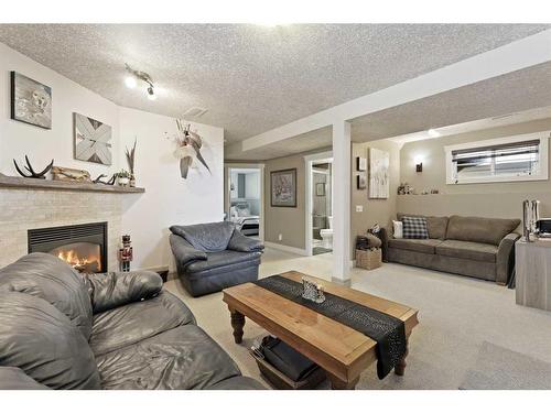 63 Coverdale Way Ne, Calgary, AB - Indoor Photo Showing Living Room With Fireplace