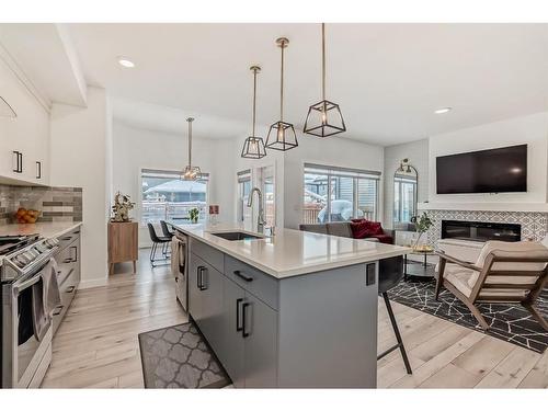 166 Creekstone Way Sw, Calgary, AB - Indoor Photo Showing Kitchen With Fireplace With Upgraded Kitchen