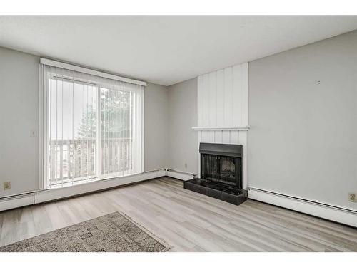 202-219 Huntington Park Bay Nw, Calgary, AB - Indoor Photo Showing Living Room With Fireplace