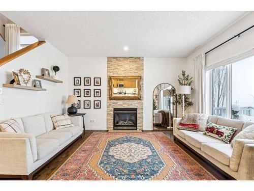 117 Drake Landing View, Okotoks, AB - Indoor Photo Showing Living Room With Fireplace