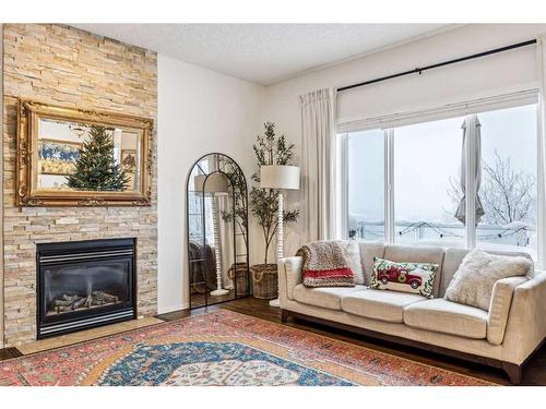 117 Drake Landing View, Okotoks, AB - Indoor Photo Showing Living Room With Fireplace