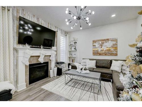 122 Osborne Rise Sw, Airdrie, AB - Indoor Photo Showing Living Room With Fireplace