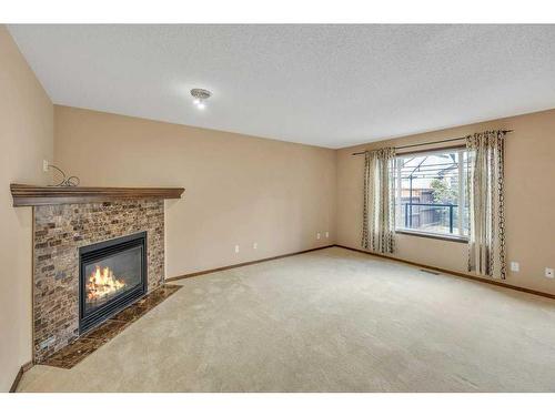 1920 New Brighton Drive Se, Calgary, AB - Indoor Photo Showing Living Room With Fireplace