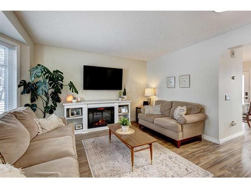 311 Mt Lorette Place Se, Calgary, AB - Indoor Photo Showing Living Room With Fireplace