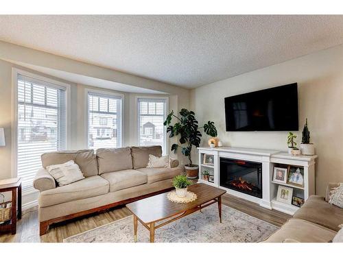 311 Mt Lorette Place Se, Calgary, AB - Indoor Photo Showing Living Room With Fireplace