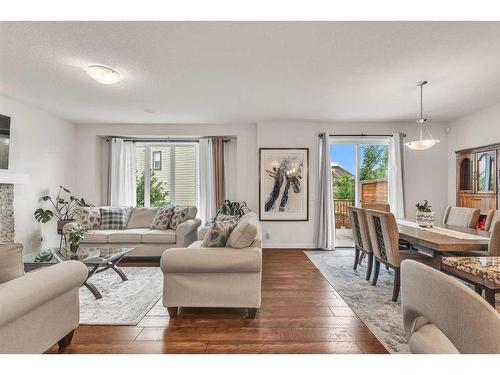 16 Masters Way Se, Calgary, AB - Indoor Photo Showing Living Room With Fireplace