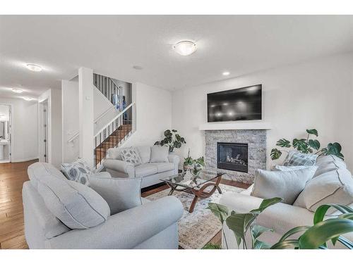 16 Masters Way Se, Calgary, AB - Indoor Photo Showing Living Room With Fireplace