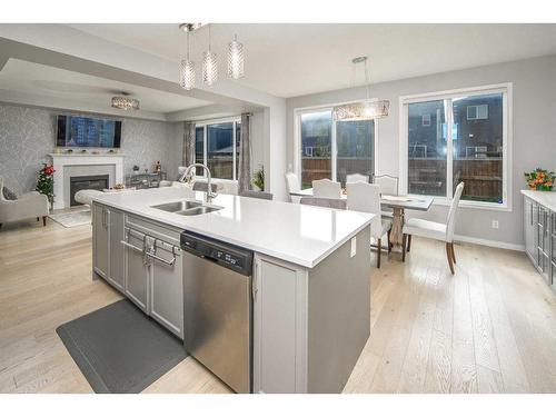 24 Carrington Rise Nw, Calgary, AB - Indoor Photo Showing Kitchen With Fireplace With Double Sink