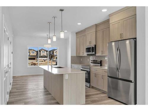 938 Cobblemore Common Sw, Airdrie, AB - Indoor Photo Showing Kitchen With Stainless Steel Kitchen With Upgraded Kitchen