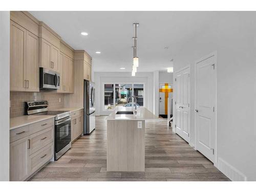 938 Cobblemore Common Sw, Airdrie, AB - Indoor Photo Showing Kitchen With Stainless Steel Kitchen With Upgraded Kitchen