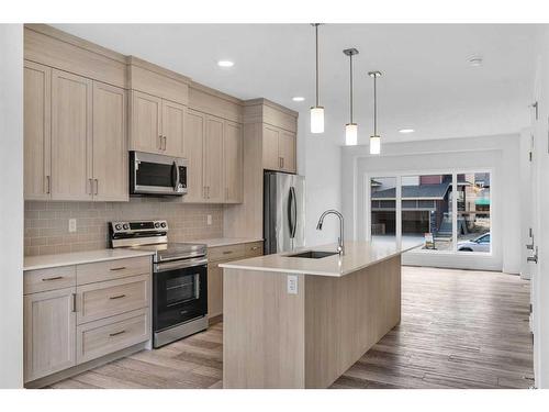 938 Cobblemore Common Sw, Airdrie, AB - Indoor Photo Showing Kitchen With Stainless Steel Kitchen With Upgraded Kitchen