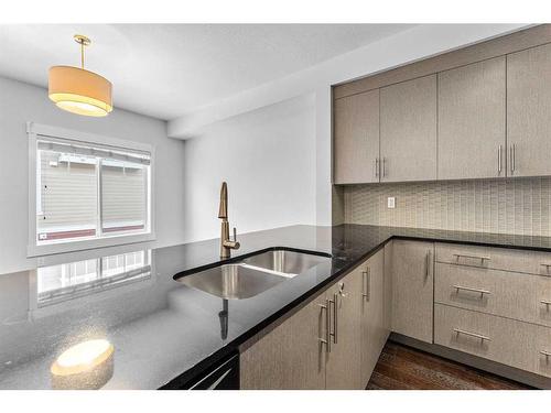 52 West Caoch Manor Sw, Calgary, AB - Indoor Photo Showing Kitchen With Double Sink