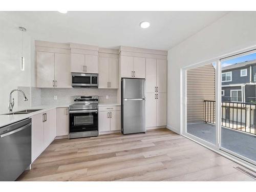 103-75 Cornerstone Row Ne, Calgary, AB - Indoor Photo Showing Kitchen With Double Sink