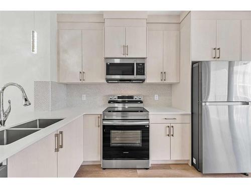 103-75 Cornerstone Row Ne, Calgary, AB - Indoor Photo Showing Kitchen With Double Sink With Upgraded Kitchen