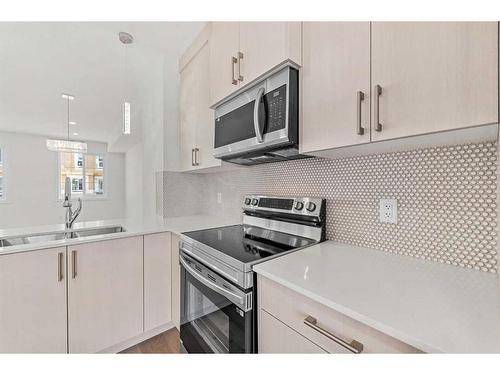 103-75 Cornerstone Row Ne, Calgary, AB - Indoor Photo Showing Kitchen With Double Sink