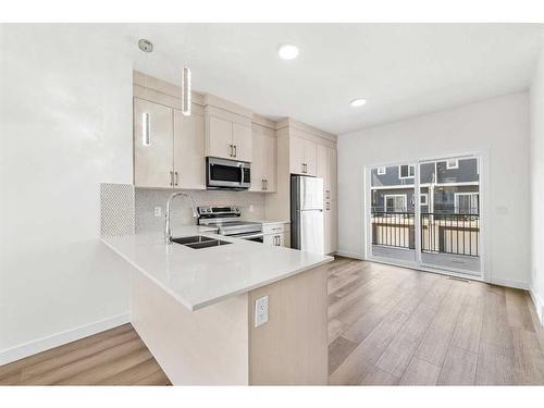 103-75 Cornerstone Row Ne, Calgary, AB - Indoor Photo Showing Kitchen With Double Sink With Upgraded Kitchen