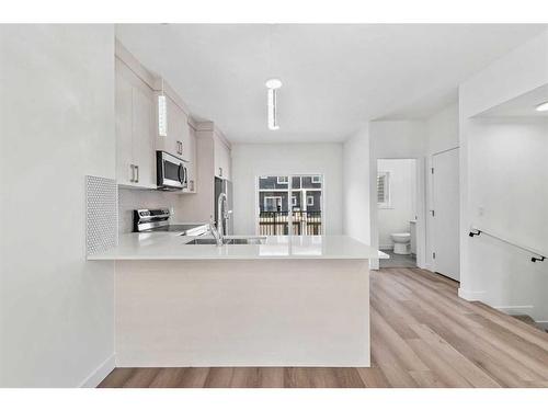 103-75 Cornerstone Row Ne, Calgary, AB - Indoor Photo Showing Kitchen With Double Sink