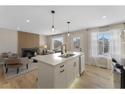 114 Bridleridge Circle Sw, Calgary, AB - Indoor Photo Showing Kitchen With Fireplace With Double Sink