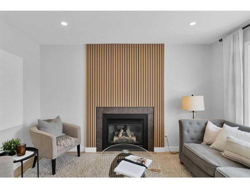 114 Bridleridge Circle Sw, Calgary, AB - Indoor Photo Showing Living Room With Fireplace