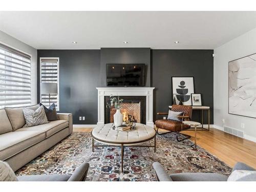 3 Spring Mews Sw, Calgary, AB - Indoor Photo Showing Living Room With Fireplace