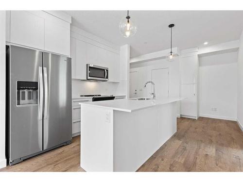 1304-111 Wolf Creek Drive Se, Calgary, AB - Indoor Photo Showing Kitchen With Stainless Steel Kitchen With Upgraded Kitchen