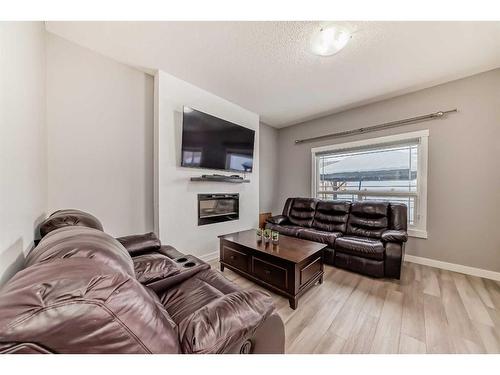 43 Baysprings Way Sw, Airdrie, AB - Indoor Photo Showing Living Room With Fireplace