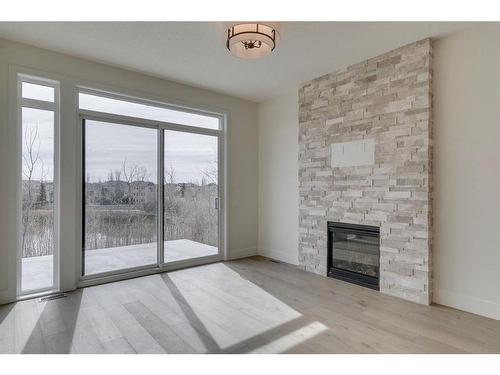 71 Royal Birch Cove Nw, Calgary, AB - Indoor Photo Showing Other Room With Fireplace