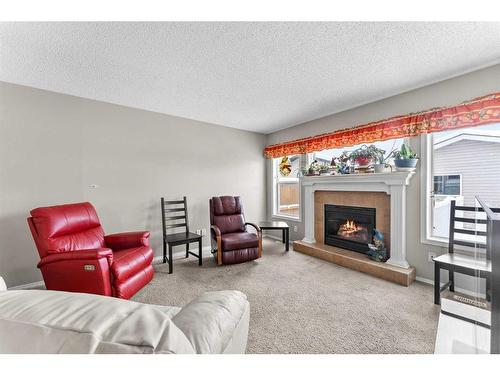 195 Cranberry Close Se, Calgary, AB - Indoor Photo Showing Living Room With Fireplace