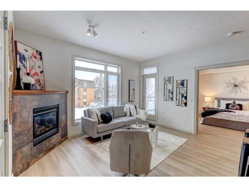 205-2 Hemlock Crescent Sw, Calgary, AB - Indoor Photo Showing Living Room With Fireplace